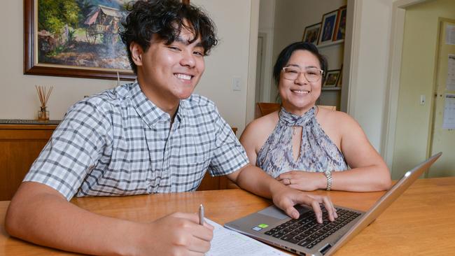 Nico Cacayorin and his mum Cherrie work on his resume at home. Picture: Brenton Edwards