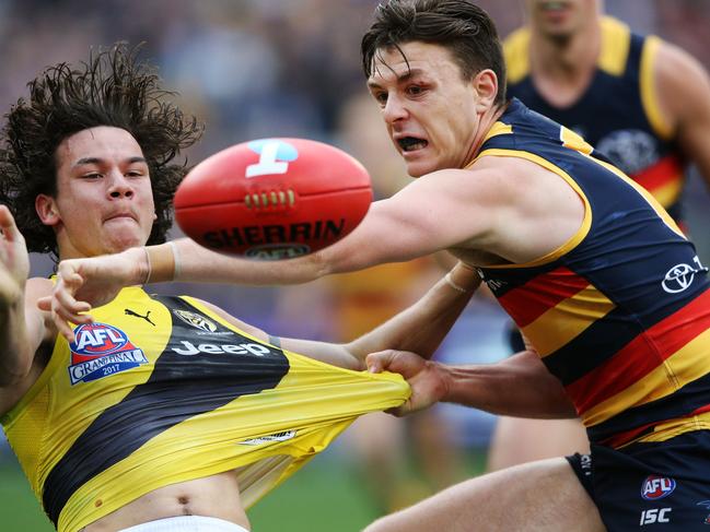 MELBOURNE, VICTORIA - SEPTEMBER 30:  Daniel Rioli of the Tigers (L) and Jake Lever of the Crows compete for the ball during the 2017 AFL Grand Final match between the Adelaide Crows and the Richmond Tigers at Melbourne Cricket Ground on September 30, 2017 in Melbourne, Australia.  (Photo by Michael Dodge/AFL Media/Getty Images)