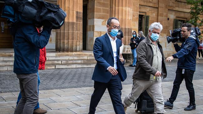 Dr Randy De Los Reyes Juanata, left in blue, leaves the Adelaide Magistrates Court on Wednesday. Picture: Tom Huntley