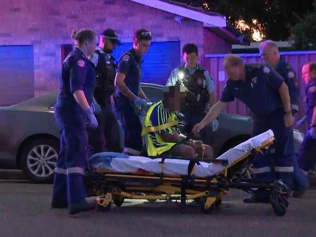 One man was wheeled out in a chair before being placed onto a stretcher. Picture: TNV