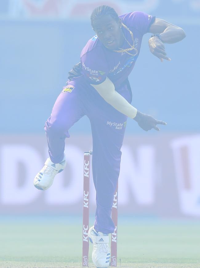 Jofra Archer of the Hurricanes bowls in a bushfire smoke haze during the Big Bash League (BBL) match between the Hobart Hurricanes and the Brisbane Heat at Blundstone Arena in Hobart tonight. 