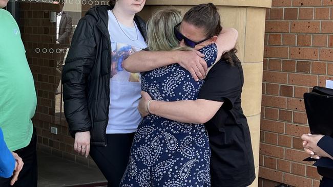 Kylie Stewart and Miranda McLaughlin embracing after Maurice Blackburn Lawyers spoke to media. Picture by Simon McGuire.