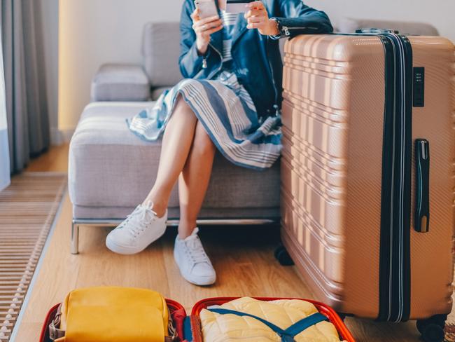 Woman in the hotel texting on smartphone