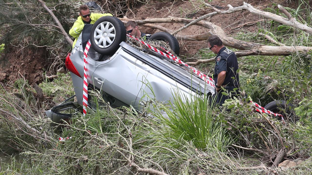 A car found washed off Clagiraba Weir in the Gold Coast hinterland after heavy rains and flash flooding. Picture: Glenn Hampson