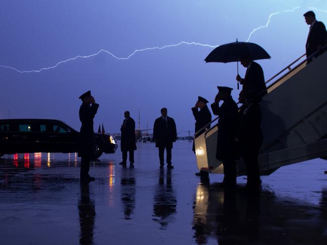 Donald Trump disembarks from Air Force One as lightning splits the sky during a storm at Joint Base Andrews in Maryland. Picture: AFP