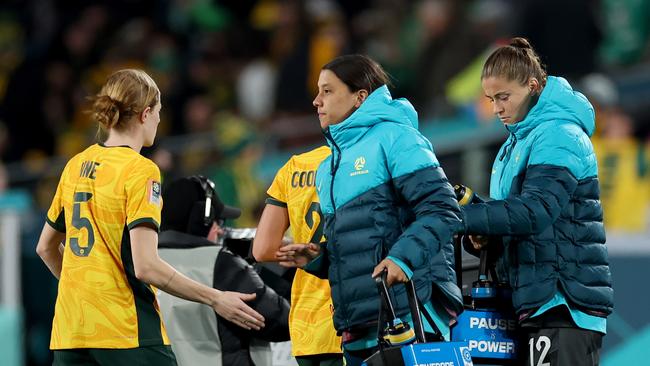 Sam Kerr delivers water bottles for her teammates. (Photo by Cameron Spencer/Getty Images)