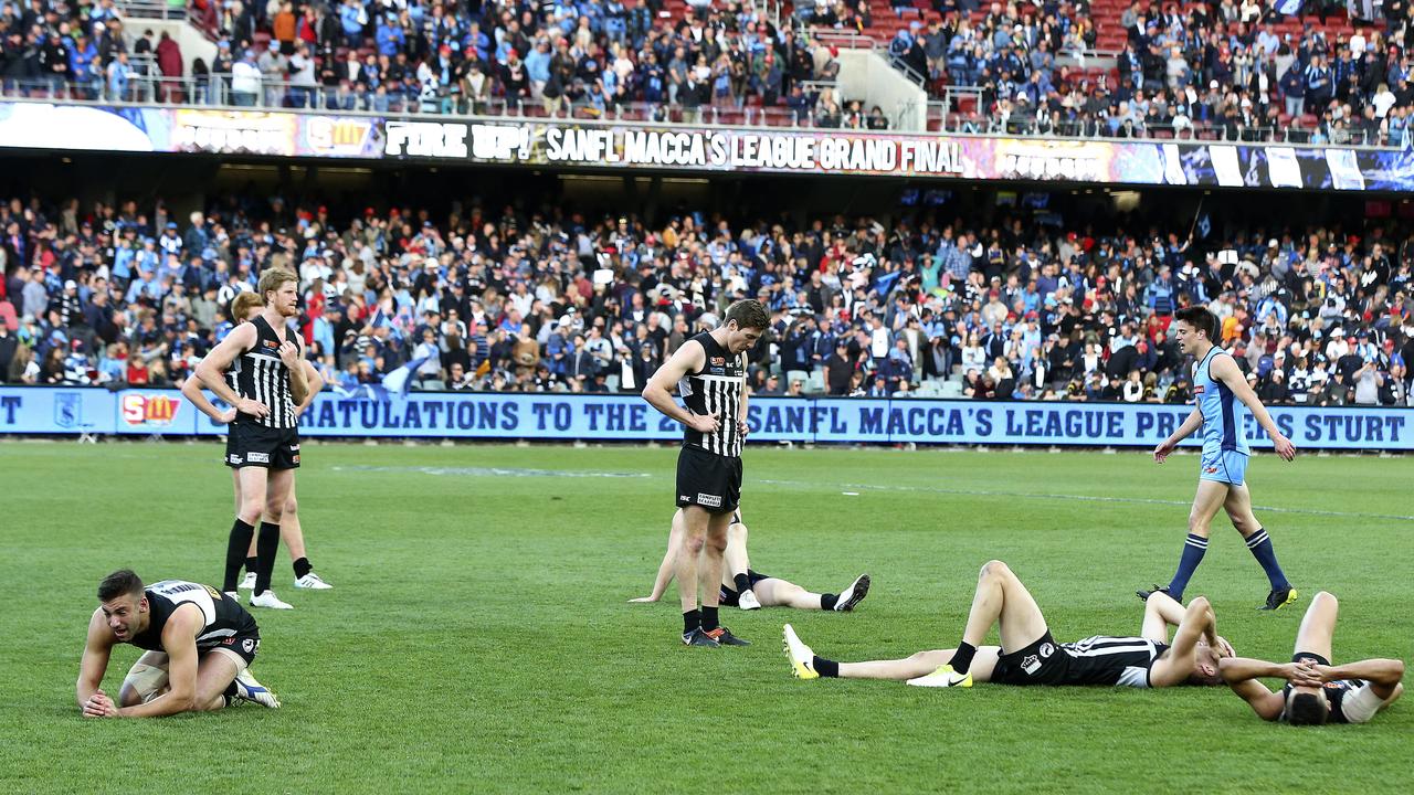 Heartbroken Port players slump on the ground after the loss. Picture Sarah Reed