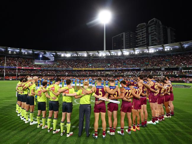 Players, coaches and officials form a circle as a symbol of support against gender-based violence before the May 5 match between the Brisbane Lions and Gold Coast Suns. Picture: Chris Hyde/AFL Photos/via Getty Images