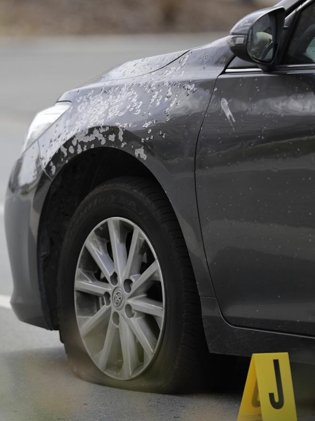 An undercover police car damaged after being shot at by Warner.