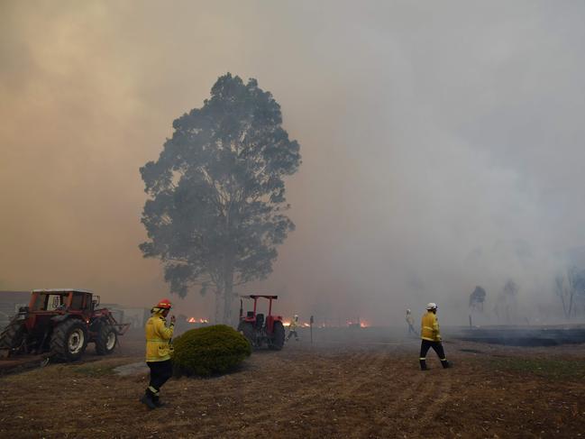 Firefighters check a property in the hope of saving it from nearby bushfires around the town of Nowra in the Australian state of New South Wales on December 31, 2019. - Thousands of holidaymakers and locals were forced to flee to beaches in fire-ravaged southeast Australia on December 31, as blazes ripped through popular tourist areas leaving no escape by land. Picture: Saeed Khan/AFP