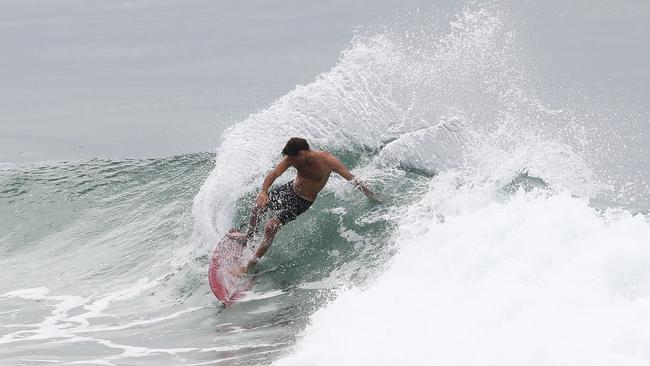 A surfer rides a wave at Burleigh on the Gold Coast. Photograph: Jason O'Brien