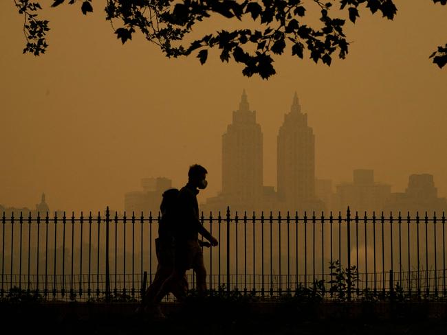 People walk in Central Park as smoke from wildfires in Canada has engulfed the Northeast and mid-Atlantic regions of the US. Picture: AFP