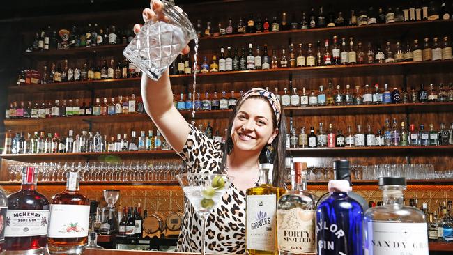 Society Salamanca co-owner Ange Nichols with Tasmanian gins she stocks at her bar. Picture: Zak Simmonds