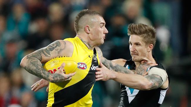 Dustin Martin fends off Port Adelaide’s Hamish Hartlett, who could have been his teammate had a trade eventuated.