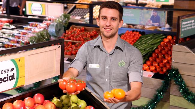 Assistant fruit and vegetable manager Jack Jones is busy stocking the section as the store readies for launch. Picture: AAP Image/Richard Gosling