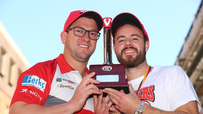 Departing North Adelaide coach Josh Carr with captain Max Thring at the traditional West End chimney unveiling after the Roosters won last year’s SANFL flag. PIC TAIT SCHMAAL.