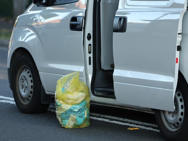 Police were seen filling bags of evidence on Thursday morning. Picture: Rohan Kelly