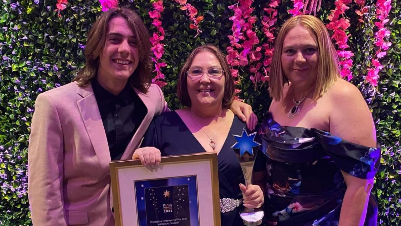 WELL DESERVED: Cheering Angela 'Angie' Brown (centre) on from the crowd are son Dylan Brown and office manager Ashlea McNellee.