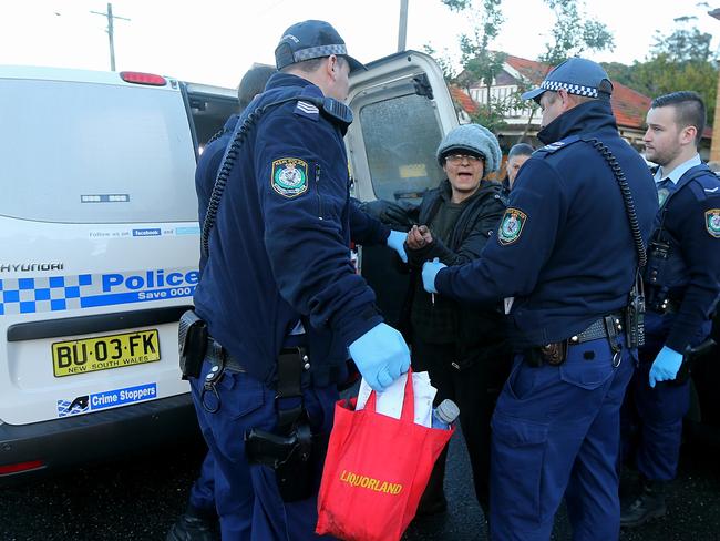 Liana Bobolas under police arrest during a council-ordered clean-up in 2015. Picture: John Grainger