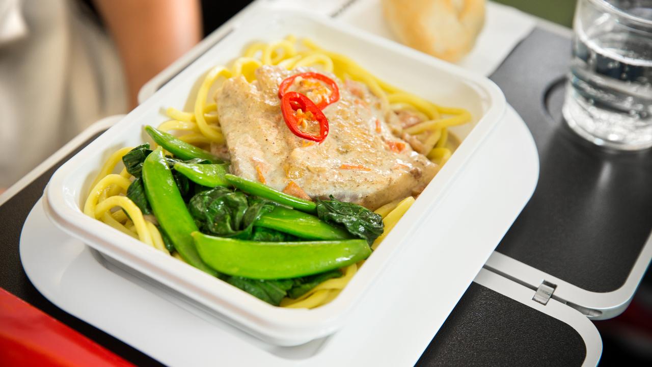 An economy meal of barramundi with noodles, on Qantas international.