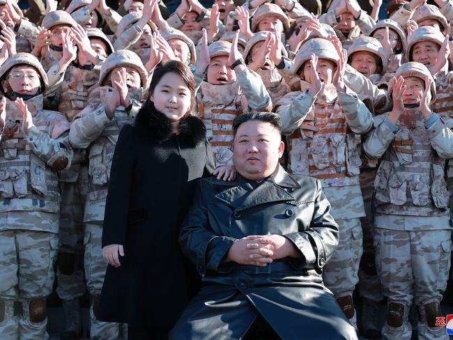 TOPSHOT - This undated picture released from North Korea's official Korean Central News Agency (KCNA) on November 27, 2022 shows North Korea's leader Kim Jong Un (front R) and his daughter (front L) posing with soldiers who contributed to the test-firing of the new intercontinental ballistic missile (ICBM), at an unknown location in North Korea. - North Korea has conducted a record-breaking blitz of missile launches in recent weeks and fears have grown that it is building up to a seventh nuclear test, its first since 2017. (Photo by KCNA VIA KNS / AFP) / South Korea OUT / REPUBLIC OF KOREA OUT ---EDITORS NOTE--- RESTRICTED TO EDITORIAL USE - MANDATORY CREDIT "AFP PHOTO/KCNA VIA KNS" - NO MARKETING NO ADVERTISING CAMPAIGNS - DISTRIBUTED AS A SERVICE TO CLIENTS / THIS PICTURE WAS MADE AVAILABLE BY A THIRD PARTY. AFP CAN NOT INDEPENDENTLY VERIFY THE AUTHENTICITY, LOCATION, DATE AND CONTENT OF THIS IMAGE --- /