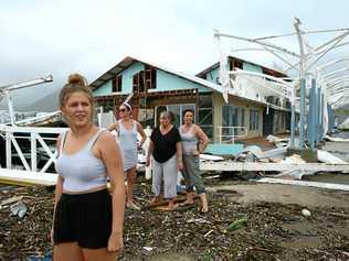 BLOWN APART: Airlie Beach residents Maika McDonald,15, Lauren Squires, Karen Gordon, and Katelin Gordon, survey the damage at Shute Harbour after cyclone Debbie. Picture: Liam Kidston