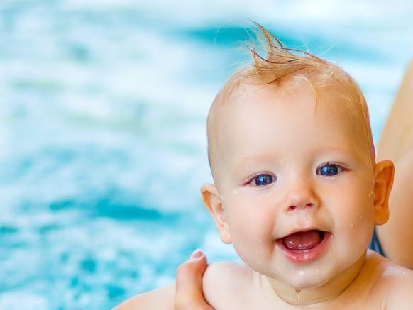 Mother and baby swim  in the pool. Baby and mother takiung part in learn to swim classes etc