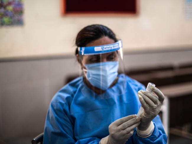 A medical workers prepares to administer a COVID-19 shot at a vaccination centre set up in a school in New Delhi, India. Picture: Getty Images