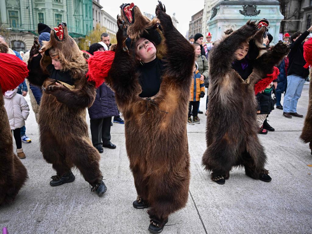 Moldovans wear bearskin as they march and dance during the International Festival of Winter Traditions in Romania. Picture: Daniel Mihailescu/AFP