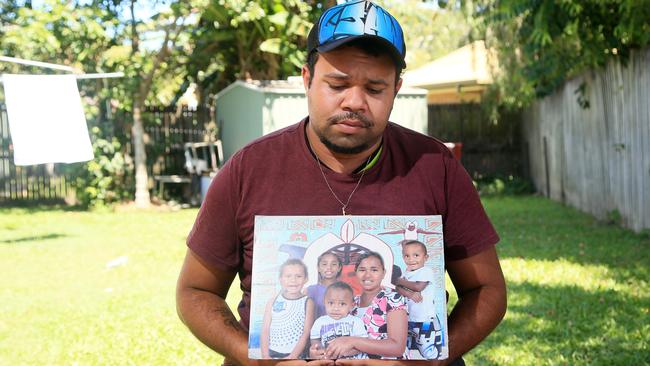 Devastated 21-year-old Lewis Warria displays a portrait of five of the victims from the tragedy. Lewis was the first person to the discover the bodies of 7 younger brothers and sisters plus a cousin on December 19, 2014. PICTURE: JUSTIN BRIERTY