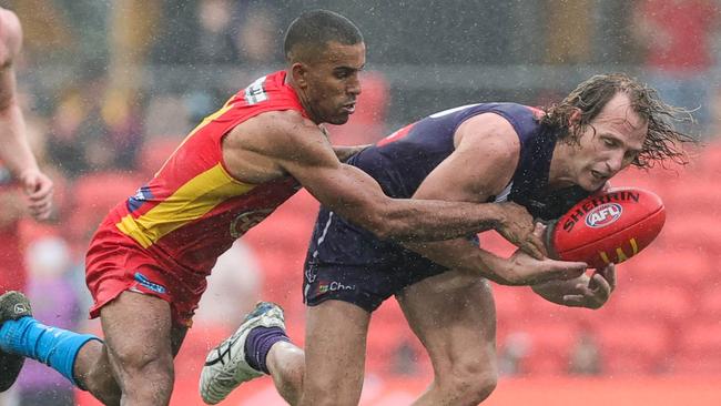 Gold Coast’s Touk Miller of tackles Docker David Mundy. Picture: Russell Freeman/AFL Photos