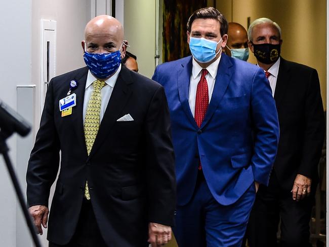 (From L) Jackson Health System President and CEO Carlos Migoya, Florida Gov. Ron DeSantis and Miami-Dade County Mayor Carlos Gimenez arrive for a press conference to address the rise of coronavirus cases in the state. Picture: AFP