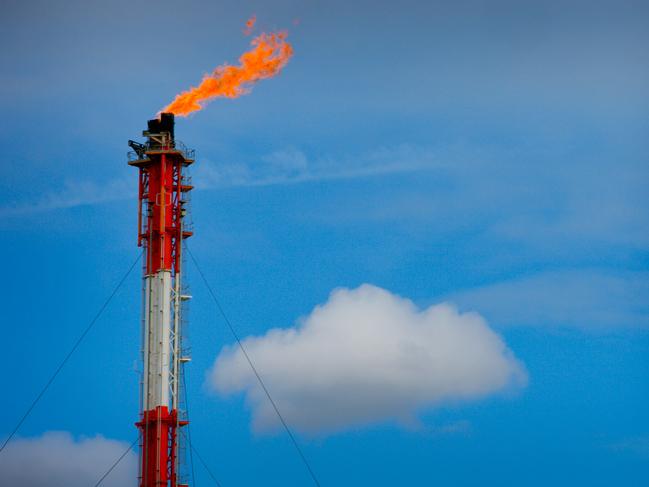 A flame blazes on top of a flare stack at the Queensland Curtis Liquefied Natural Gas (QCLNG) project site, operated by QGC Pty, a unit of Royal Dutch Shell Plc, in Gladstone, Australia, on Wednesday, June 15, 2016. Gas from more than 2,500 wells travels hundreds of miles by pipeline to the project, where it's chilled and pumped into 10-story-high tanks before being loaded onto massive ships. Photographer: Patrick Hamilton/Bloomberg via Getty Images