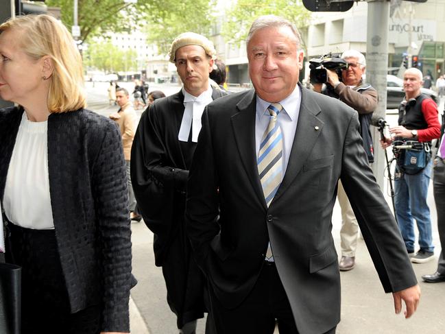 Former AWB executive Trevor Flugge returns after a lunch break with his legal team to the Supreme courts in Melbourne, Monday, Oct. 12, 2015. Flugge and fellow executive Peter Geary are facing charges brought on by ASIC for alleged breaches of their duties as offices. (AAP Image/Joe Castro) NO ARCHIVING