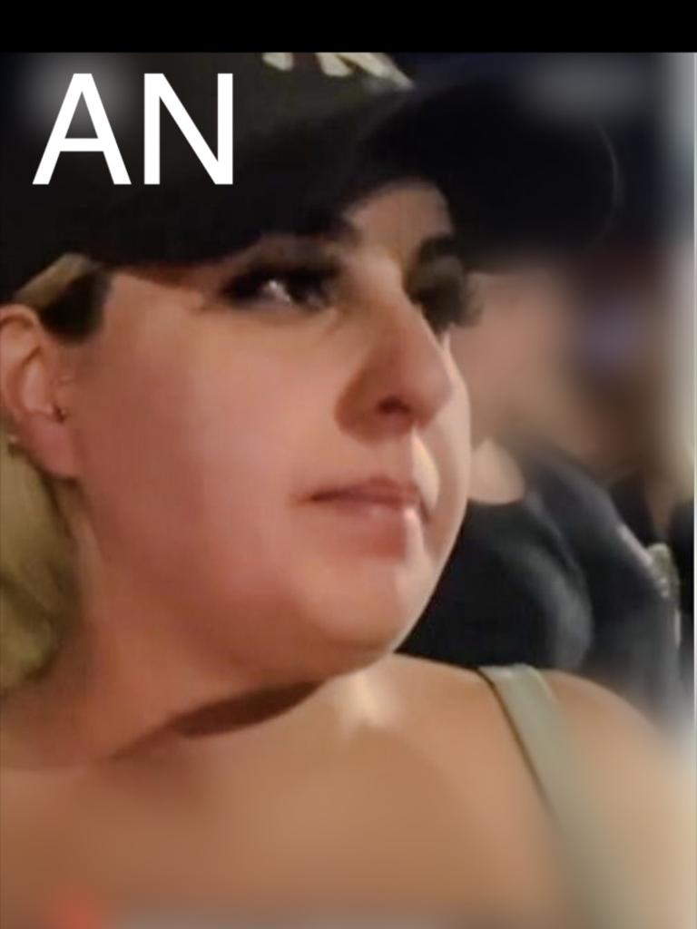 Person AN is described as being a woman of Mediterranean/Middle Eastern appearance, medium build, with blonde hair. She is shown wearing a singlet top and shorts, with a shirt tied around her waist and a dark coloured cap. Picture: Supplied / NSW Police