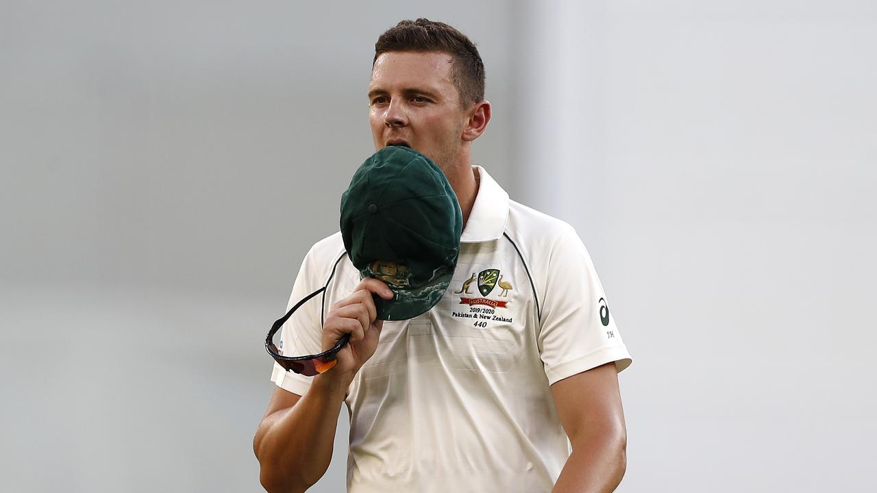 Hazlewood walks off the field after suffering his injury.