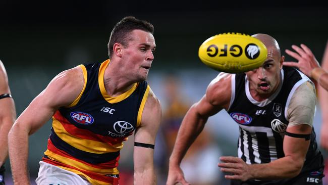 Brad Crouch of the Crows handballs during the Round 2 AFL match between the Port Adelaide Power and the Adelaide Crows at Adelaide Oval in Adelaide, Saturday, June 13, 2020. (AAP Image/David Mariuz) N