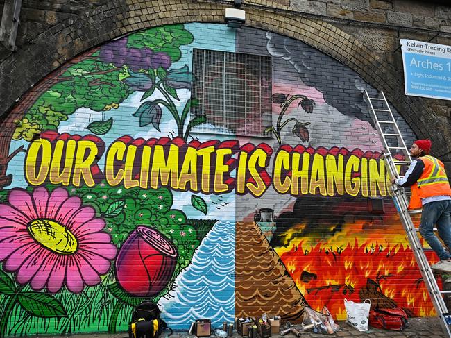 Artists paint a mural on a wall next to the Clydeside Expressway near Scottish Events Centre (SEC) which will be hosting the COP26 UN Climate Summit. Picture: Jeff J Mitchell/Getty Images