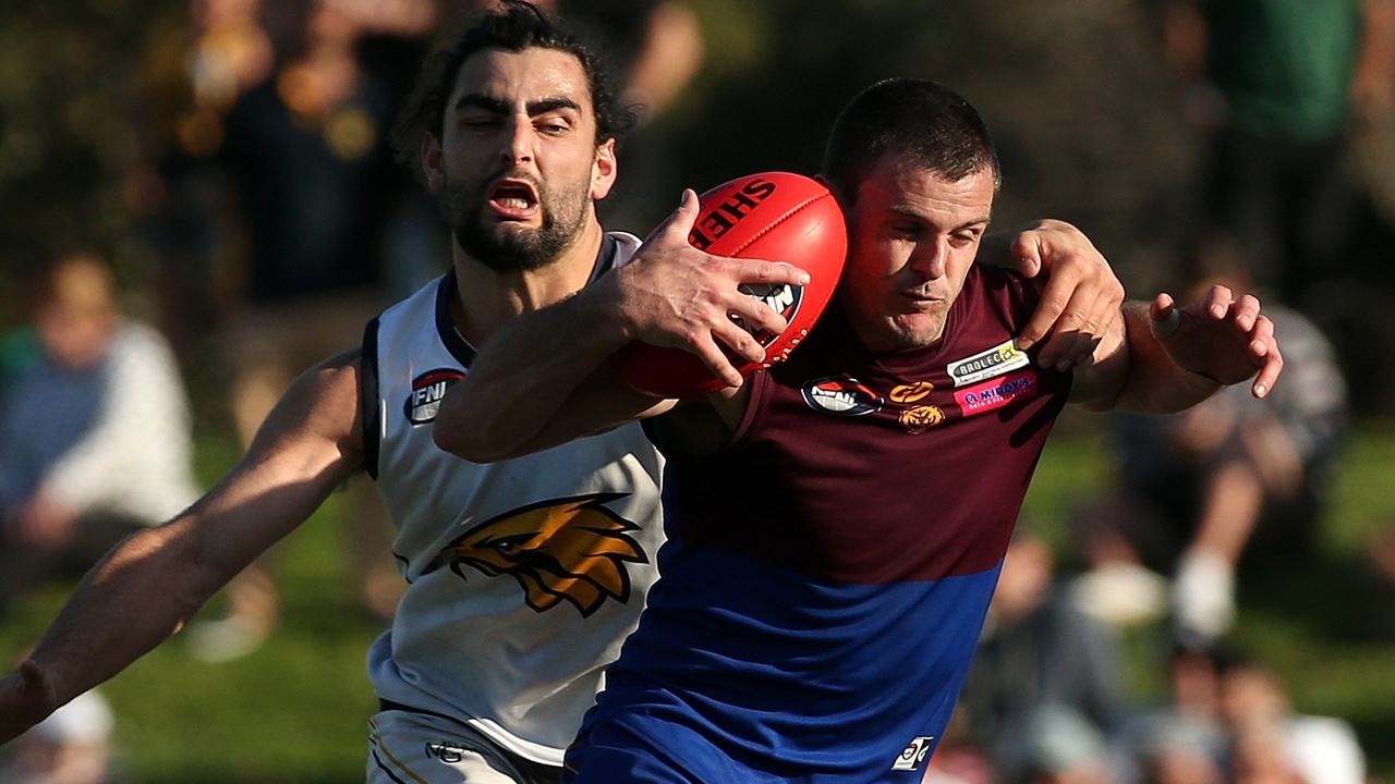 Brent Stanton is tackled by Xavier Dimasi. Picture: Hamish Blair