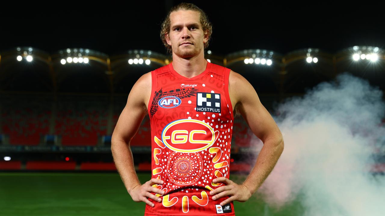 GOLD COAST, AUSTRALIA - MAY 03: Jed Anderson of the Suns poses with the Gold Coast Suns AFL Indigenous Guernsey at Heritage Bank Stadium on May 03, 2023 in Gold Coast, Australia. (Photo by Chris Hyde/Getty Images)