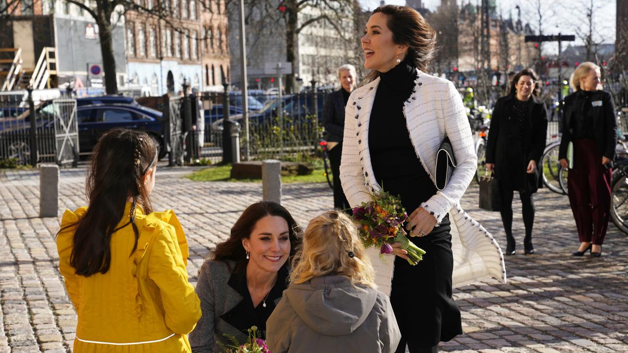 A candid moment as Kate Middleton, centre, met children at the Danner Crisis Centre. The shelter, supported by the Mary Foundation, helps women and children who have been exposed to domestic violence. Picture: Getty Images