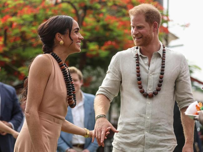 Britain's Prince Harry (R), Duke of Sussex, and Britain's Meghan (L), Duchess of Sussex, arrive at the Lightway Academy in Abuja on May 10, 2024 as they visit Nigeria as part of celebrations of Invictus Games anniversary. (Photo by sodiq adelakun / AFP)