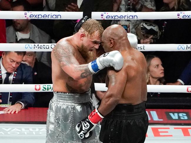 US retired pro-boxer Mike Tyson (R) and US YouTuber/boxer Jake Paul (L) hug after Paul defeated Tyson in their heavyweight boxing bout at The Pavilion at AT&T Stadium in Arlington, Texas, November 15, 2024. (Photo by TIMOTHY A. CLARY / AFP)