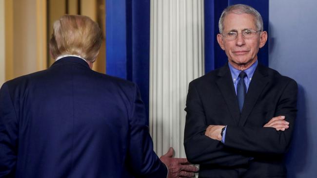 Then-US President Donald Trump departs after addressing a coronavirus task force daily briefing in March, 2020, as Dr. Anthony Fauci stands by. Picture: Reuters