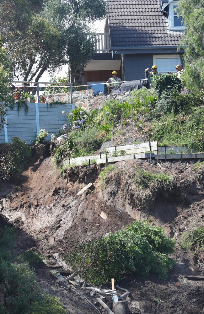 Emergency crews survey the wreckage. Picture: David Crosling