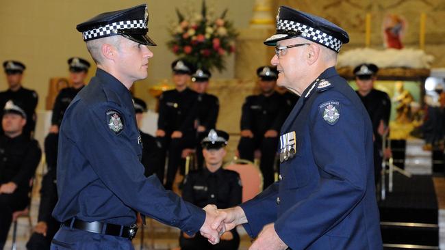 Kevin being congratulated by then-Chief Commissioner Ken Lay on his graduation day.