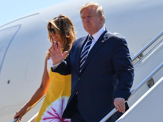 US President Donald Trump waves flanked by his wife US and First Lady Melania Trump as they disembark from an airplane upon landing at the Biarritz Pays Basque Airport in Biarritz, south-west France. Picture: AFP