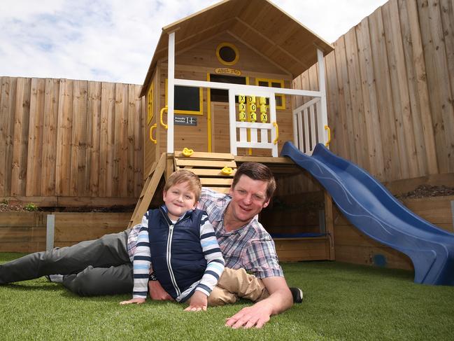 Single dad Aaron McArthur and his son, Abel, have moved into a specially built home to suit his disability, complete with cubbyhouse. Picture: Alison Wynd