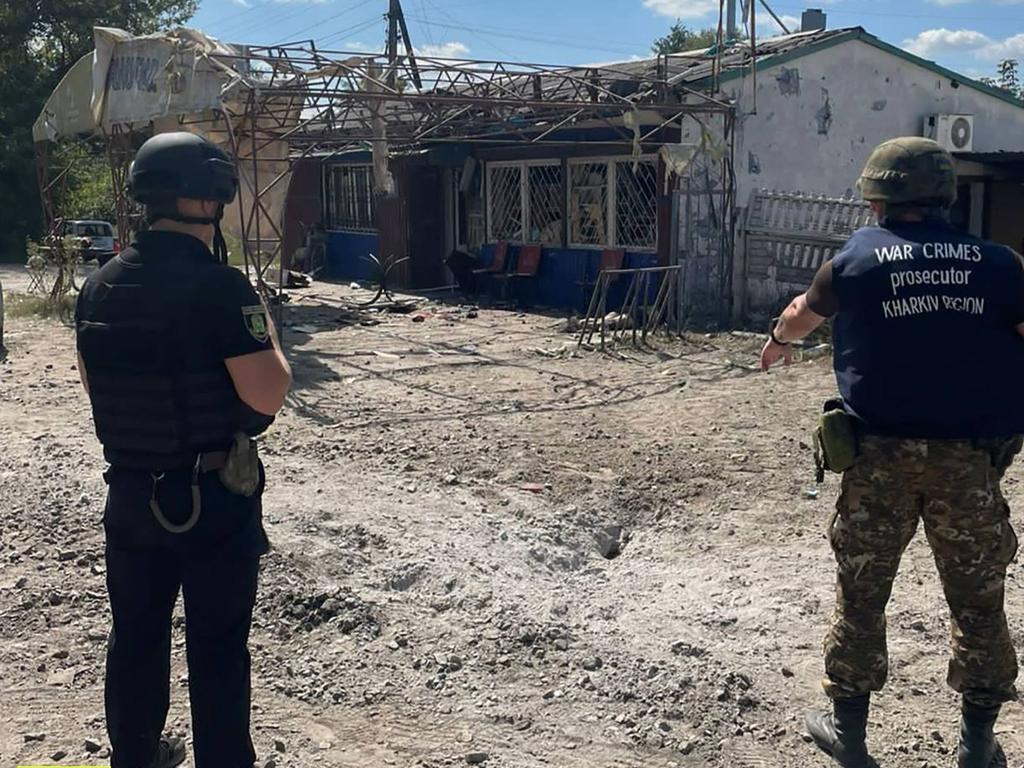 War crime prosecutors working at the site of a shelling in Podoly near the Kharviv region, where two people were reportedly killed and another found wounded as the war with Russia continues. Picture: Handout / Office of the Prosecutor General of Ukraine / AFP