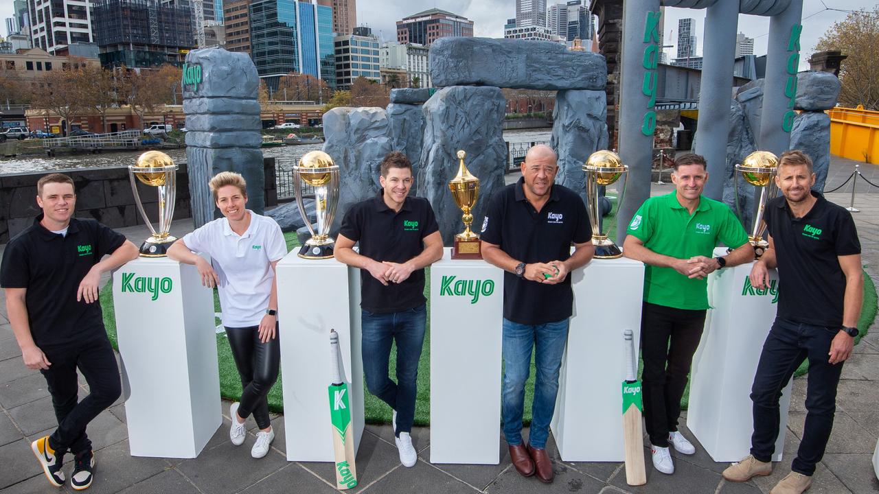 Australian players Marcus Harris, Elyse Villani, Tim Paine Andrew Symonds and Michael Hussey with Fox Cricket’s Mark Howard with Australia’s five World Cup trophies. Picture: Jay Town